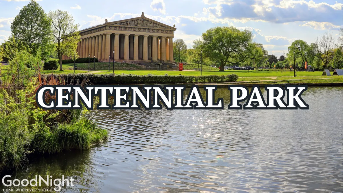 An exterior view of Nashville's Centennial Park, showcasing the iconic Parthenon replica beside a tranquil water surface and surrounded by lush greenery. The serene setting is ideal for picnics, strolls, and family activities, with wide-open spaces for children to play and adults to relax.